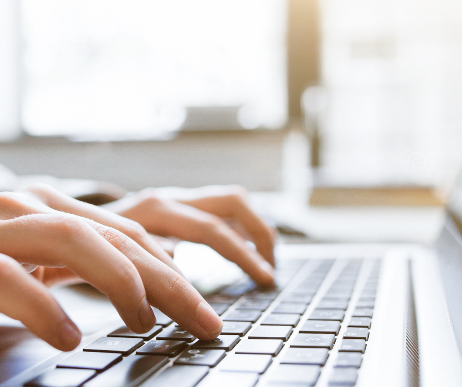 Photo of hands typing on a laptop keyboard